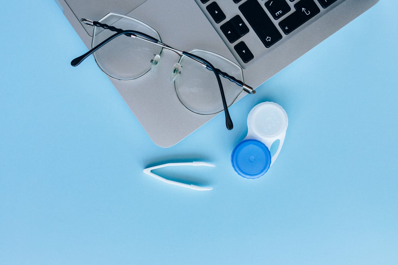 White and Blue Contact Lens Container on the Blue Table